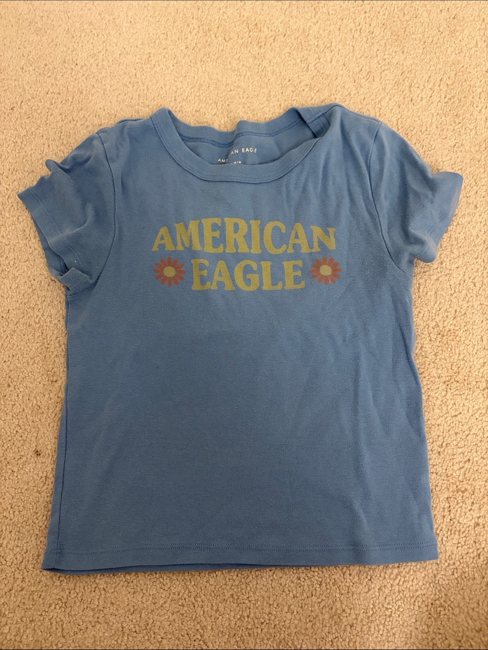 American Eagle Outfitters Blue Tee with Yellow Logo and Orange Flower Accents